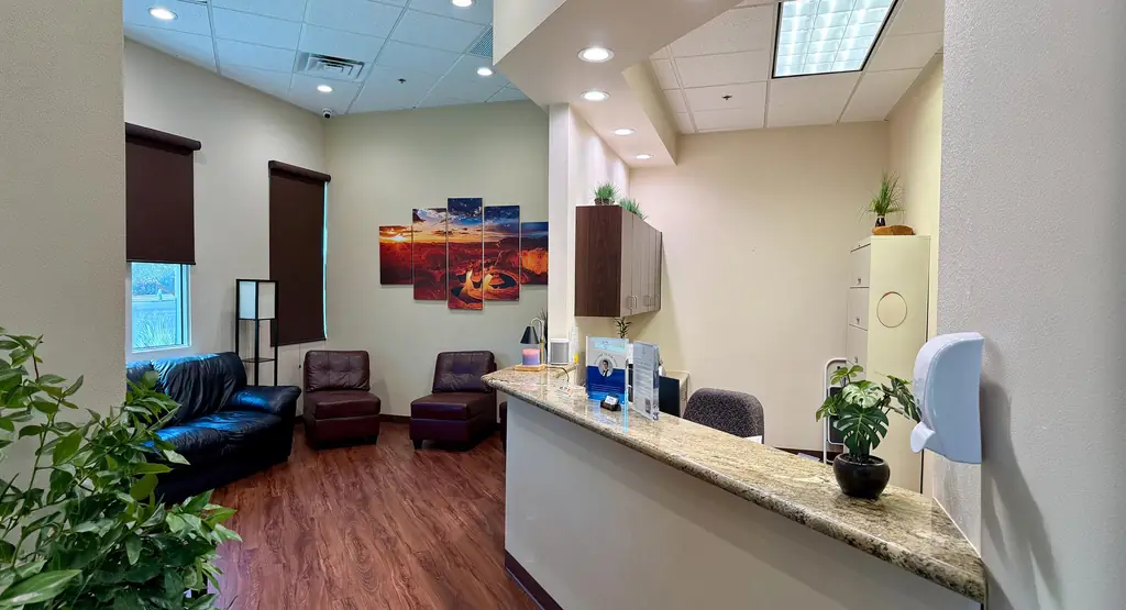 The reception at Southridge Dental Care: a granite front desk, leather chairs and a canyon print on the wall